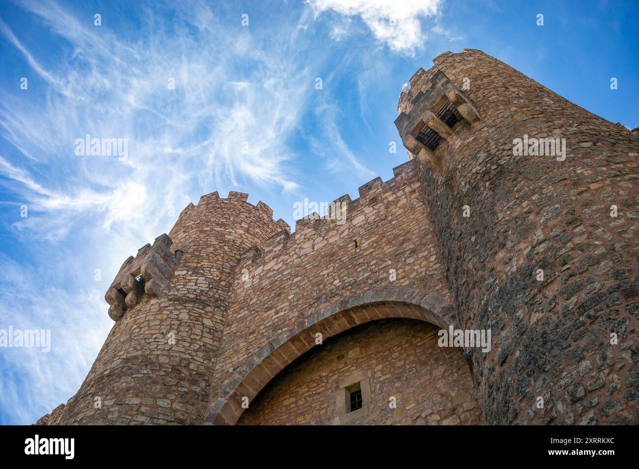 View from below of the entrance to the castle of Sigüenza, Guadalajara, Castilla-La Mancha, Spain, with its high crenellated towers Stock Photo