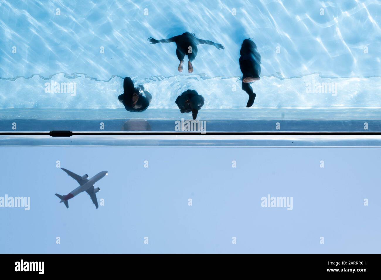 Swimmers in the Sky Pool, a transparent swimming pool suspended 35 ...