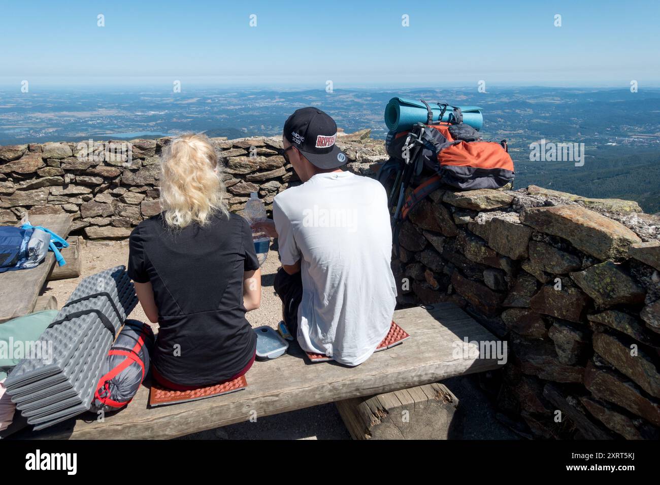 Young couple hikers resting on Top of Sniezka Mountain Poland Stock Photo