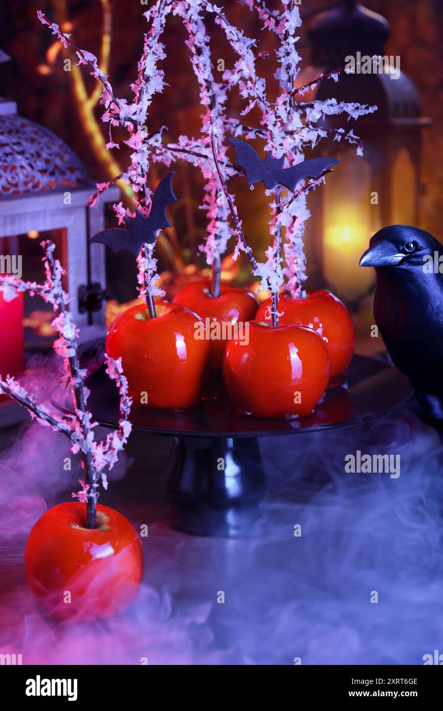 Halloween dessert. Poisoned blood caramelized glazed candy apple. Snow White Poison Lollipops. Stock Photo
