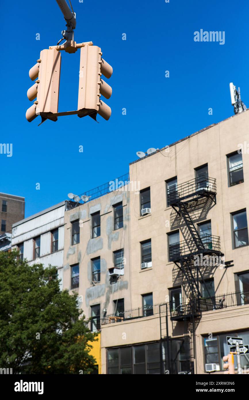 New york city architecture, street scene with overhead traffic lights hanging from a tall pole. Stock Photo