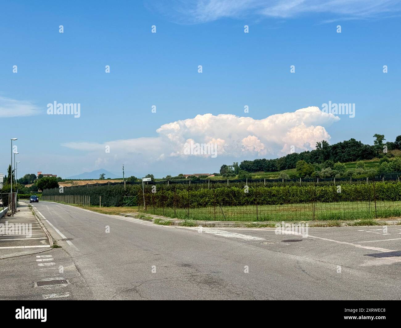 Via del Garda, Salionze. 12th August 2024. Heatwave conditions in Northern Italy at the same time as the current heatwave in the UK. Temperatures in Northern Italy reached 46C by late afternoon in the village of Salzione near Lake Garda. Cumulonimbus thunderclouds building up in the distance. Credit: james jagger/Alamy Live News Stock Photo