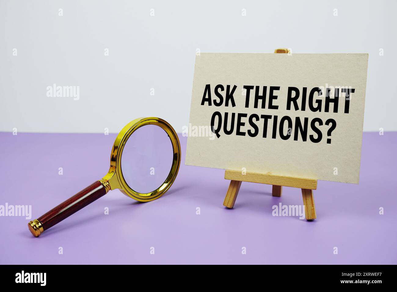Ask the right questions? text with magnifying glass on purple ...