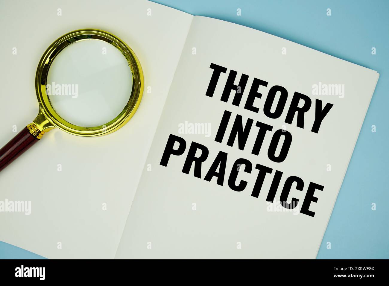 Theory Into Practice text message written on note page with magnifying ...