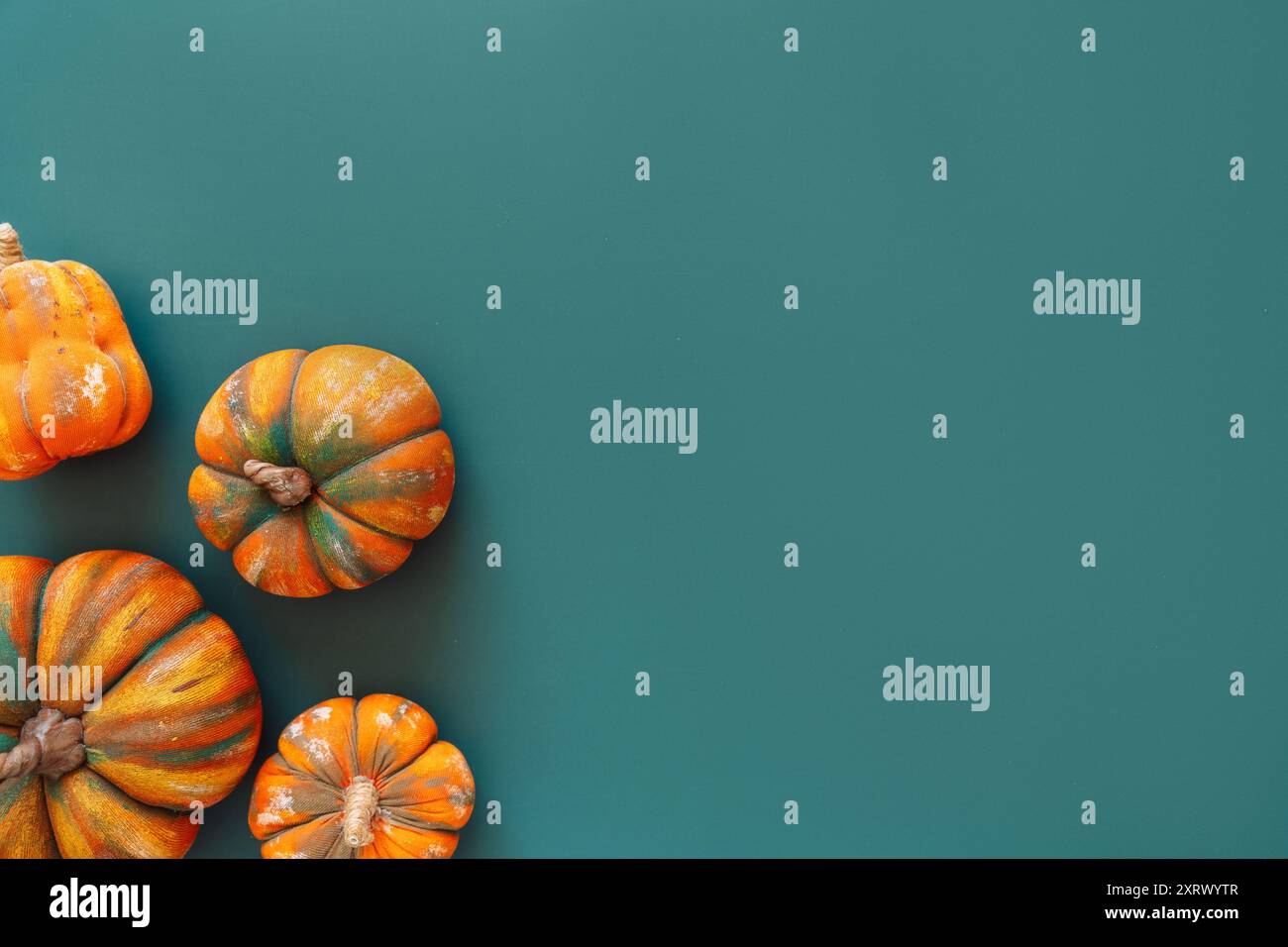 Artificial pumpkins on a green background Stock Photo - Alamy