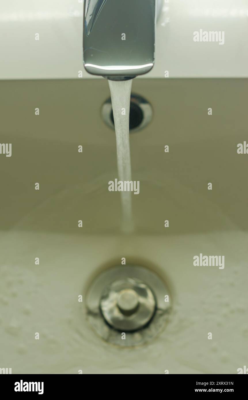Water tap , faucet. Flow water in bathroom with sink.Hygiene concept.High quality photo Stock Photo