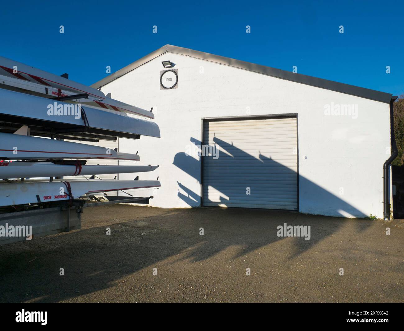 Local Rowing Boathouse Racked sculls outside Radley boathouse by the Thames create these ...