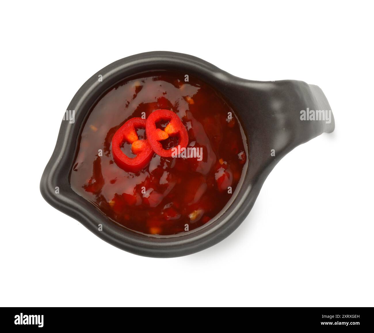 Hot chili sauce in gravy boat isolated on white, top view Stock Photo