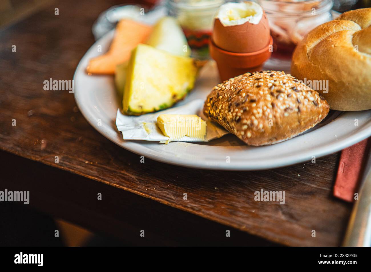 Small Package of Butter on a Breakfast Plate with Buns Stock Photo