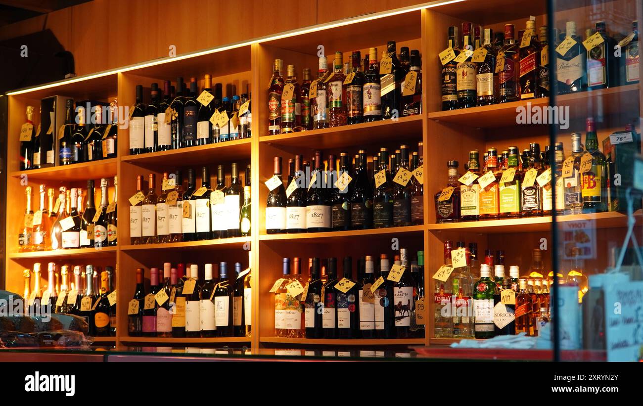 Bucharest, Romania - May 24, 2024: Wines and spirits alcoholic drinks bottles on shelves in small specialty shop Stock Photo