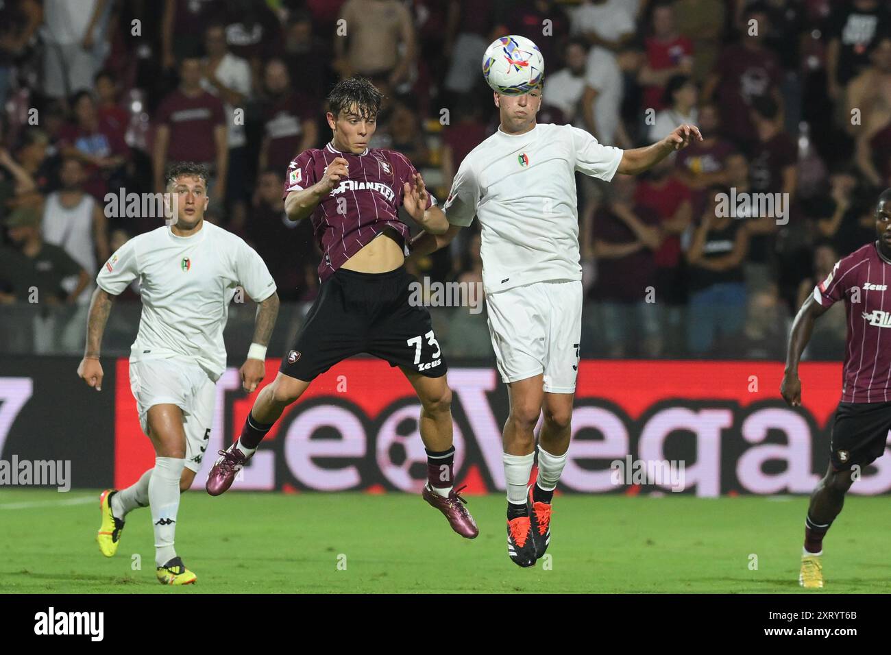 Lorenzo Amatucci of US Salernitana 1919 competes for the ball with Diego  Falcinelli of Spezia Calcio