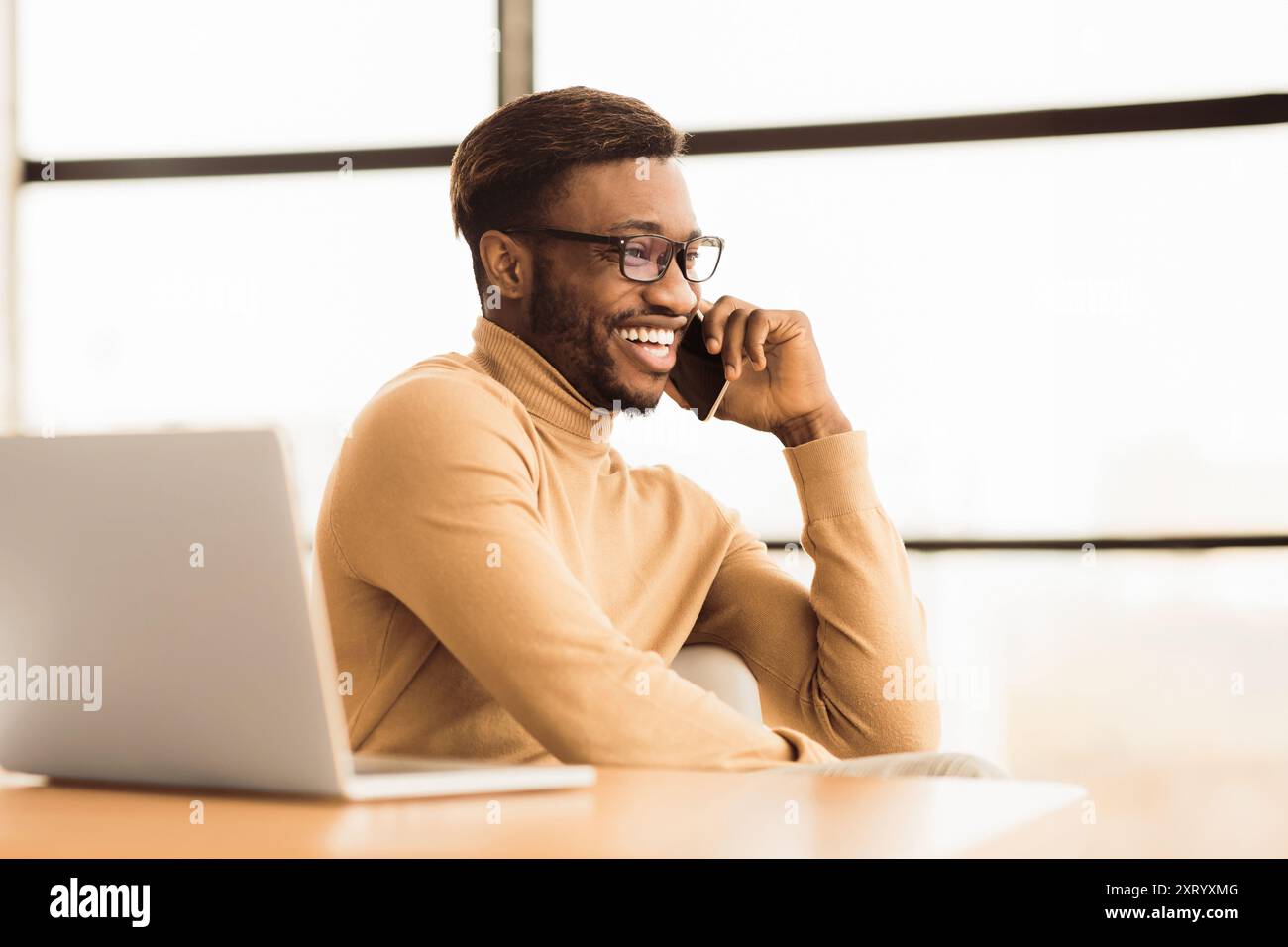 Cheerful black guy talking on the phone Stock Photo