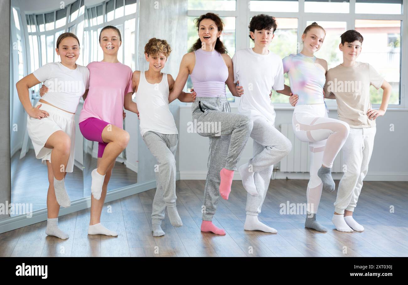 Boys and girls teenagers choreography students perform Irish dance with female teacher Stock Photo