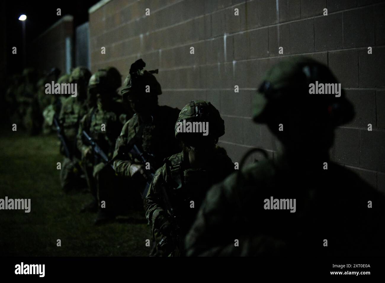 British Army reservists from the 3rd Battalion, Royal Anglian Regiment, known as “The Steelbacks,” conduct simulated urban operations and night attack during Exercise Northern Strike 24-2 at the Combined Armed Collective Training Facility, Camp Grayling, Michigan, Aug. 12, 2024. Northern Strike 24-2, one of the Department of Defense's largest reserve component readiness exercises, is scheduled to take place at Michigan's National All Domain Warfighting Center (NADWC) from August 3-17, 2024. Over 6,300 participants from 32 states and territories and several international participants will conve Stock Photo