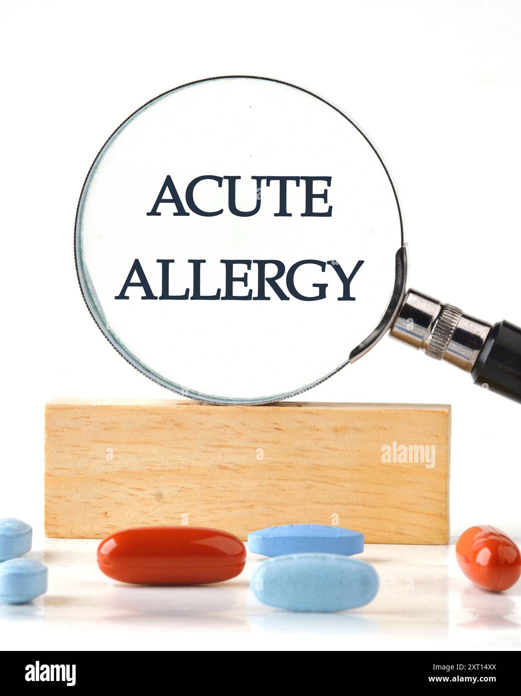 Medicine and health concept. Text ACUTE ALLERGY through a magnifying glass on a wooden block in front of a white background, a vertical photo Stock Photo