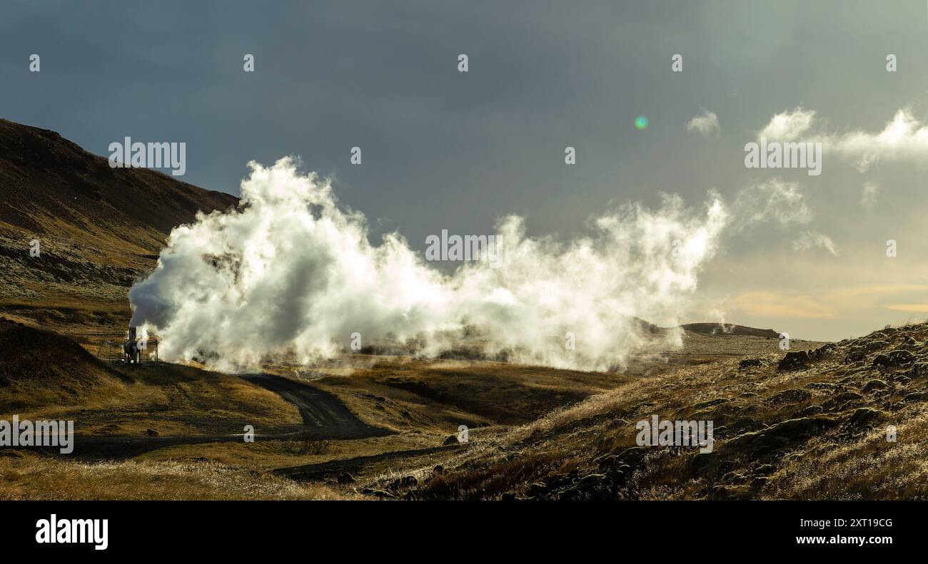 a geyser fills the air of an Icelandic volcanic landscape with water ...