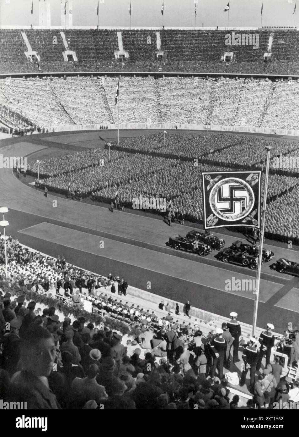 A photograph shows the Hitler Youth gathered before Adolf Hitler on May 1st. This event was part of the Nazi regime’s efforts to showcase and indoctrinate German youth, emphasizing their loyalty and commitment to the Führer and the ideals of the Third Reich. The image reflects the regime's focus on shaping the next generation to carry forward its ideology. Stock Photo