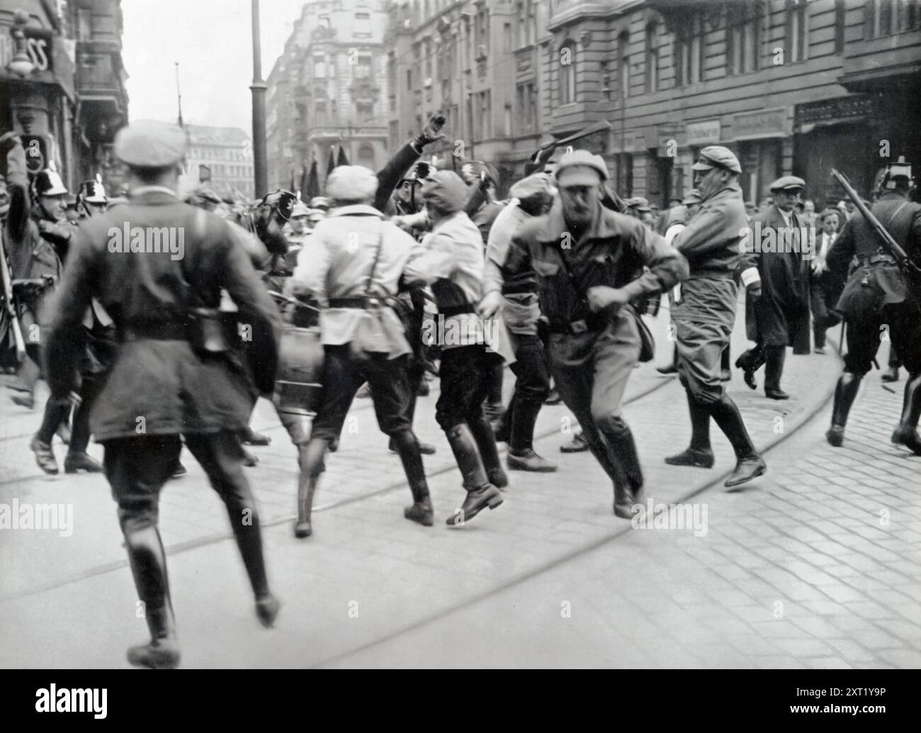 A photograph captures scenes of communist protests and riots on the streets. Such events were portrayed by the Nazi regime as significant threats to social order, reinforcing their anti-communist narrative and justifying authoritarian measures. This image would have been used in propaganda to emphasize the dangers of communism and the perceived need for strong, centralized control to maintain stability in Germany. Stock Photo