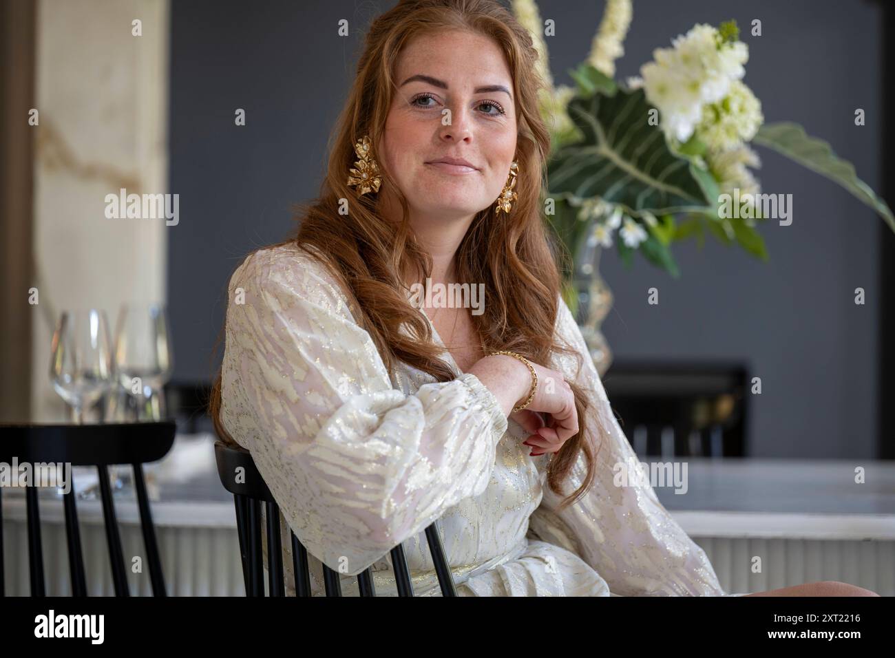 Woman wearing gold earrings hi-res stock photography and images - Alamy
