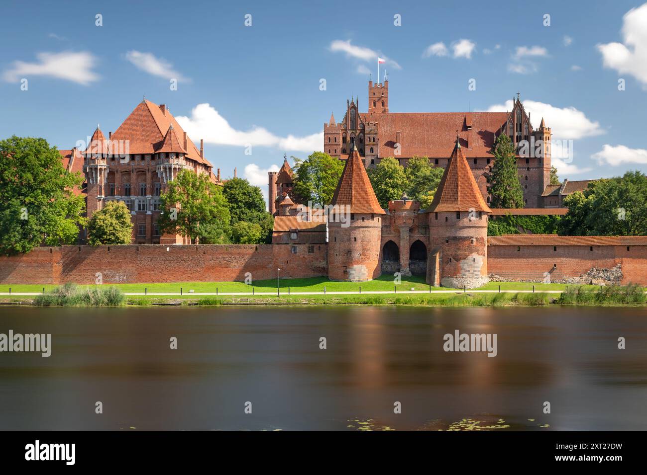 View of Malbork Castle (Zamek w Malborku) from other side of Nogat river. Long exposure shot Stock Photo