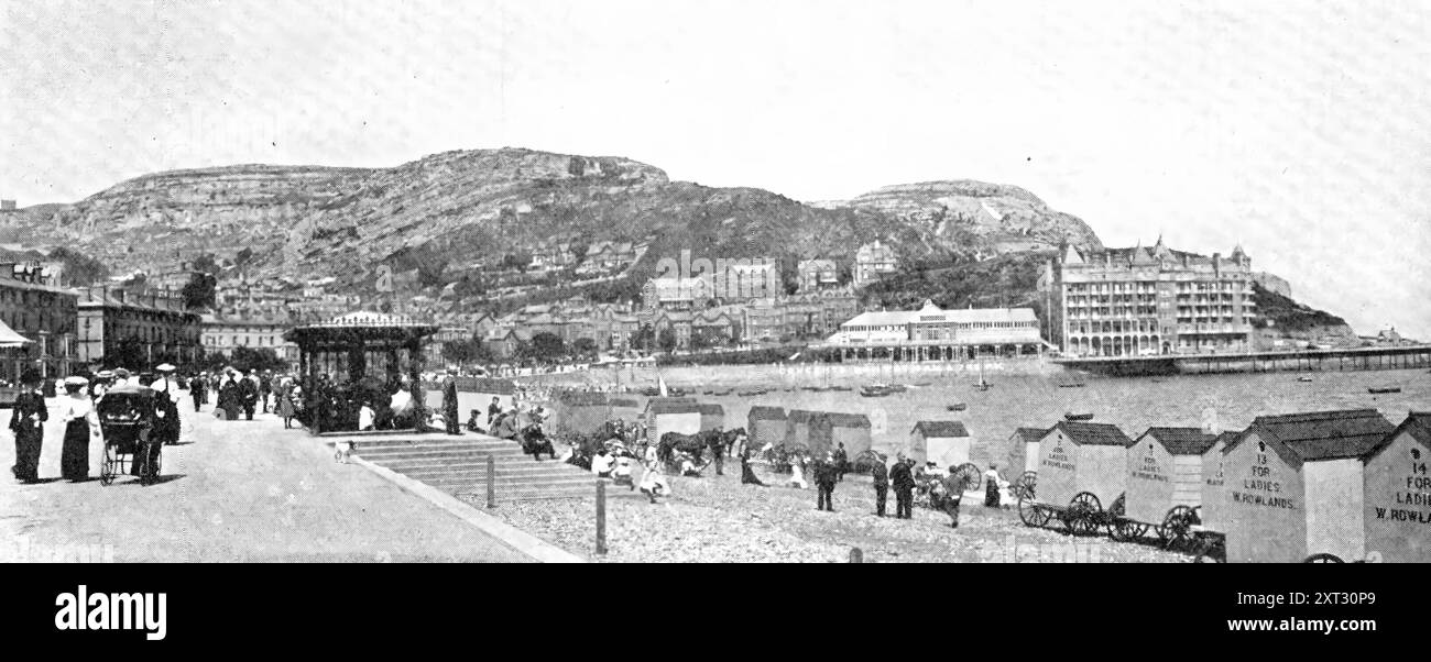 Beauty Spots In North Wales: 'The Queen of Welsh Watering-Places&quot;: the Promenade at Llandudno, 1909. 'Largely through the enterprise of the London and North Western Railway Company, which has increased and improved its train service to North Wales, that delightful district is being more and more patronised by holidaymakers from all parts of the country. Llandudno, which has been called &quot;the queen of Welsh watering places,&quot; is situated in a beautiful bay, amid grand cliff and mountain scenery, and provides attractions - bathing, boating, excursions, and entertainments to suit all Stock Photo