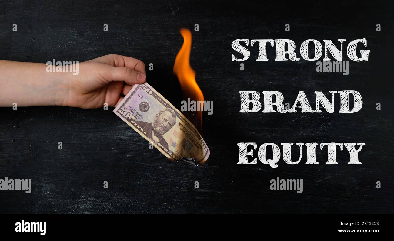 A hand holding a burnt dollar bill with the words strong brand