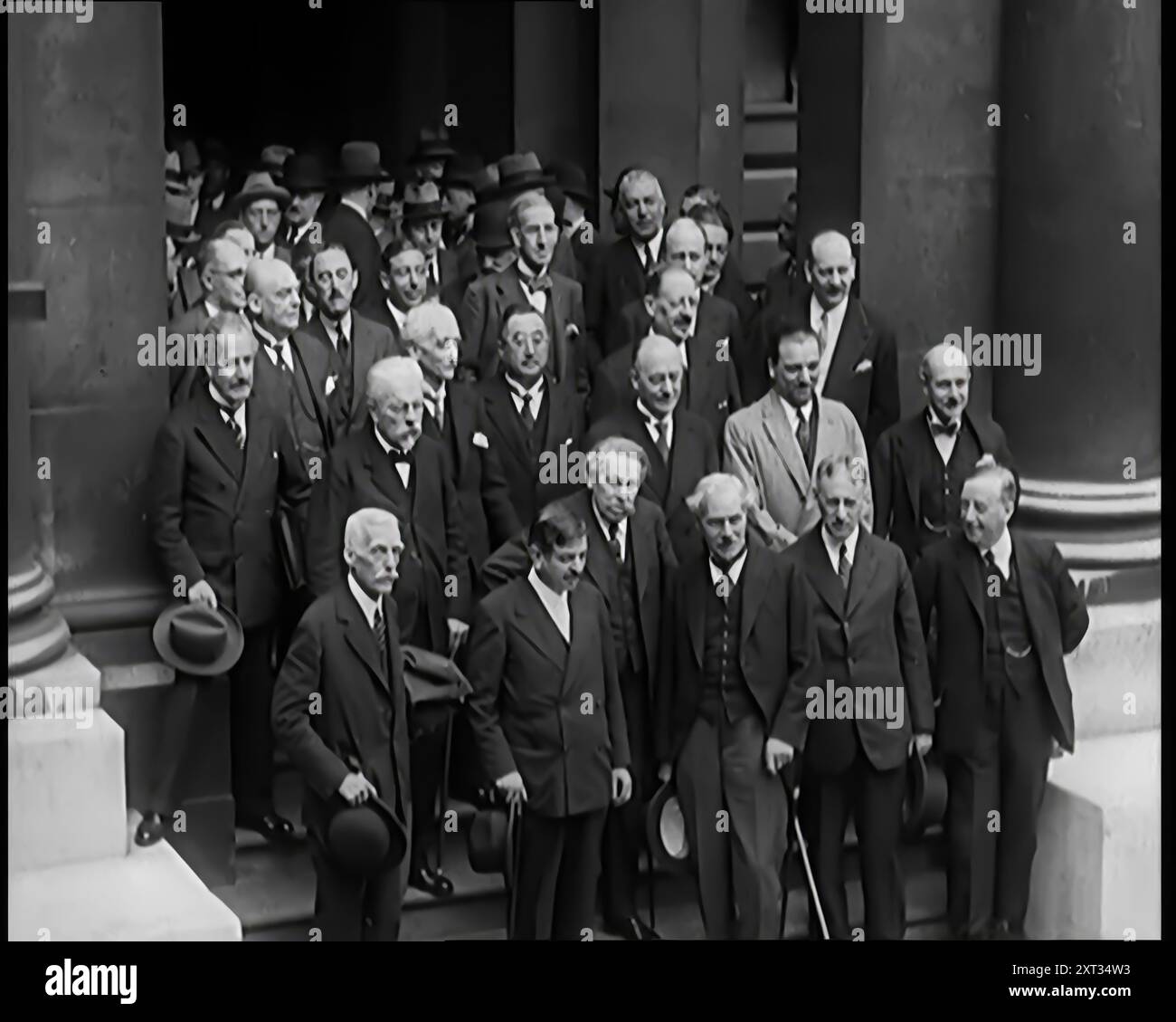 International Leaders Gathering on the Steps of a Building for a Conference on Economic Stability and Disarmament. Ramsay MacDonald, French politicians Aristide Briand, Pierre Laval, Italian Foreign Minister Dino, conte di Grandi, and American Secretary of State Henry L Stimson among them, 1931. 'First, the new broom would sweep for peace. In London the leaders of seven major powers were meeting to discuss international stability and disarmament...We even had a Germany in the League of Nations. An air of real trying, as though at last all were united at last in realisation of war's absurdity. Stock Photo