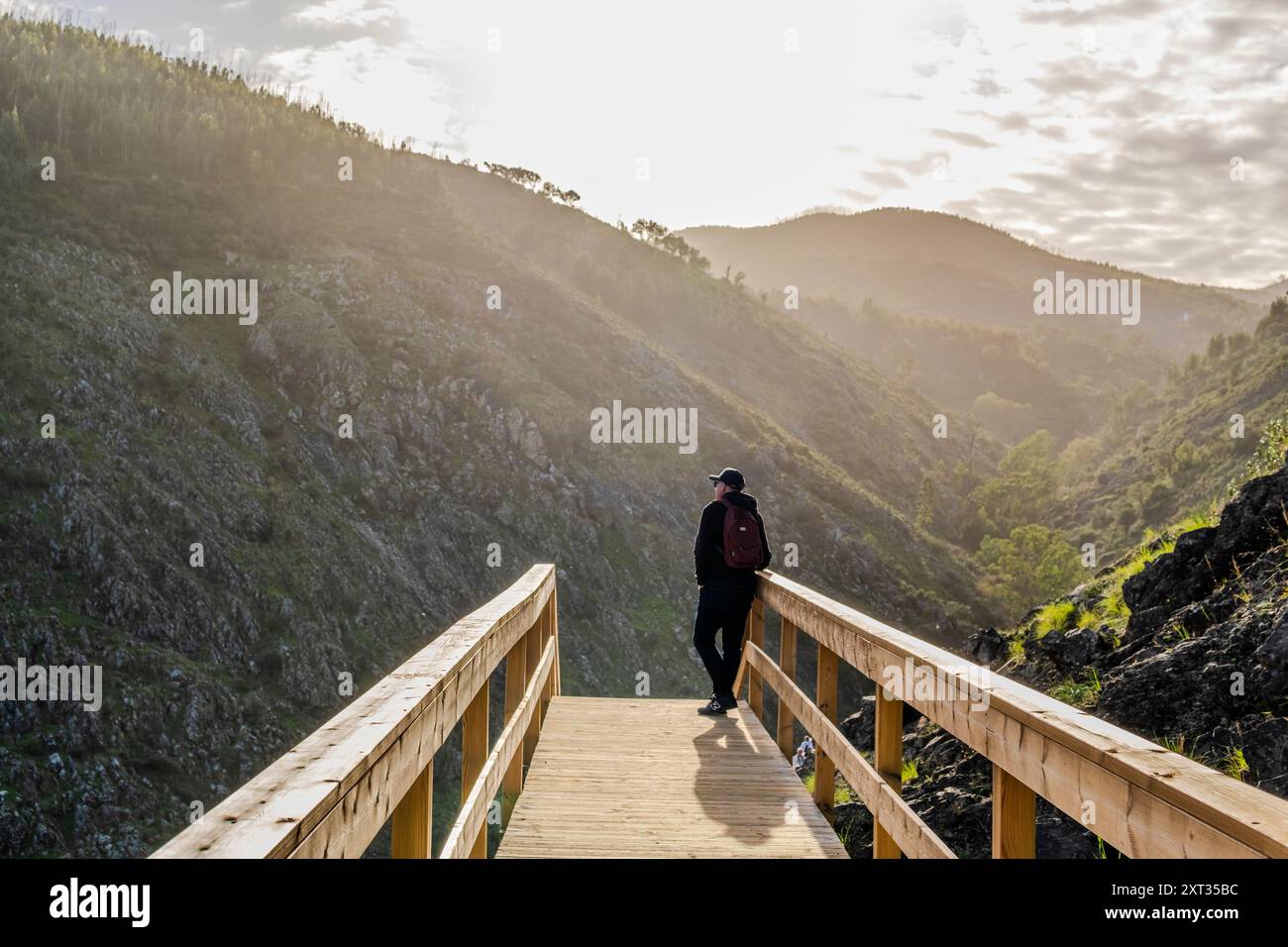 A man contemplating the beauty of the mointains from  boardwalk in Alferce, Algarve, Portugal Stock Photo