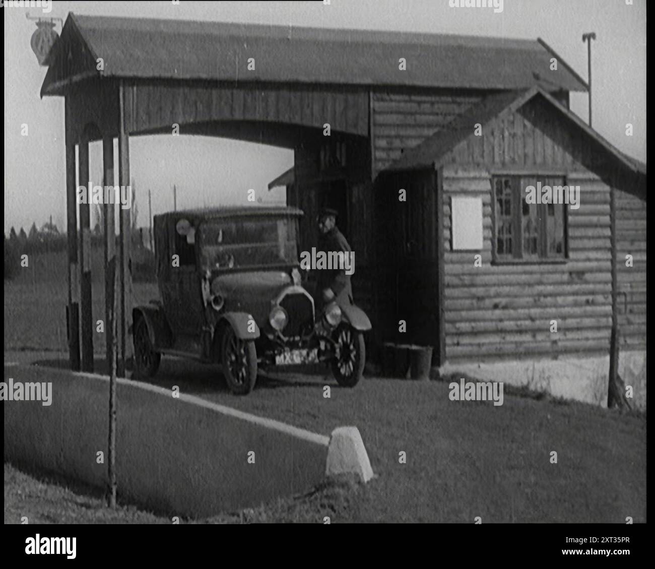 A Motorcar Driving Into the Forecourt of the First Petrol Station 