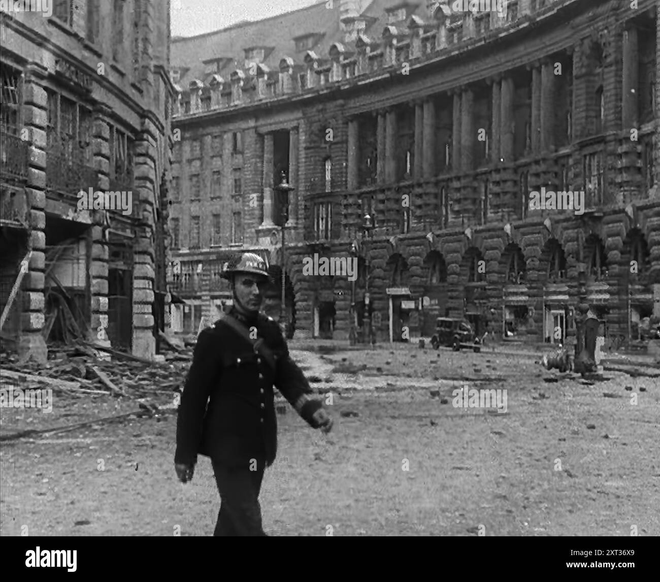 Air Raid Wardens in Bombed Out Streets, 1940. Britain during the Second World War: the Blitz. 'Any night, any time, summer 1940. Fire and flame, death and destruction...Any morning-after in London...They've shut off Regent Street and Piccadilly this morning - unexploded bomb. But it's being steamed out nicely, they say. It'll soon be made harmless, but they're right to keep the streets closed'. From &quot;Time To Remember -  Standing Alone&quot;, 1940 (Reel 4); documentary film about events of later months of 1940. Stock Photo