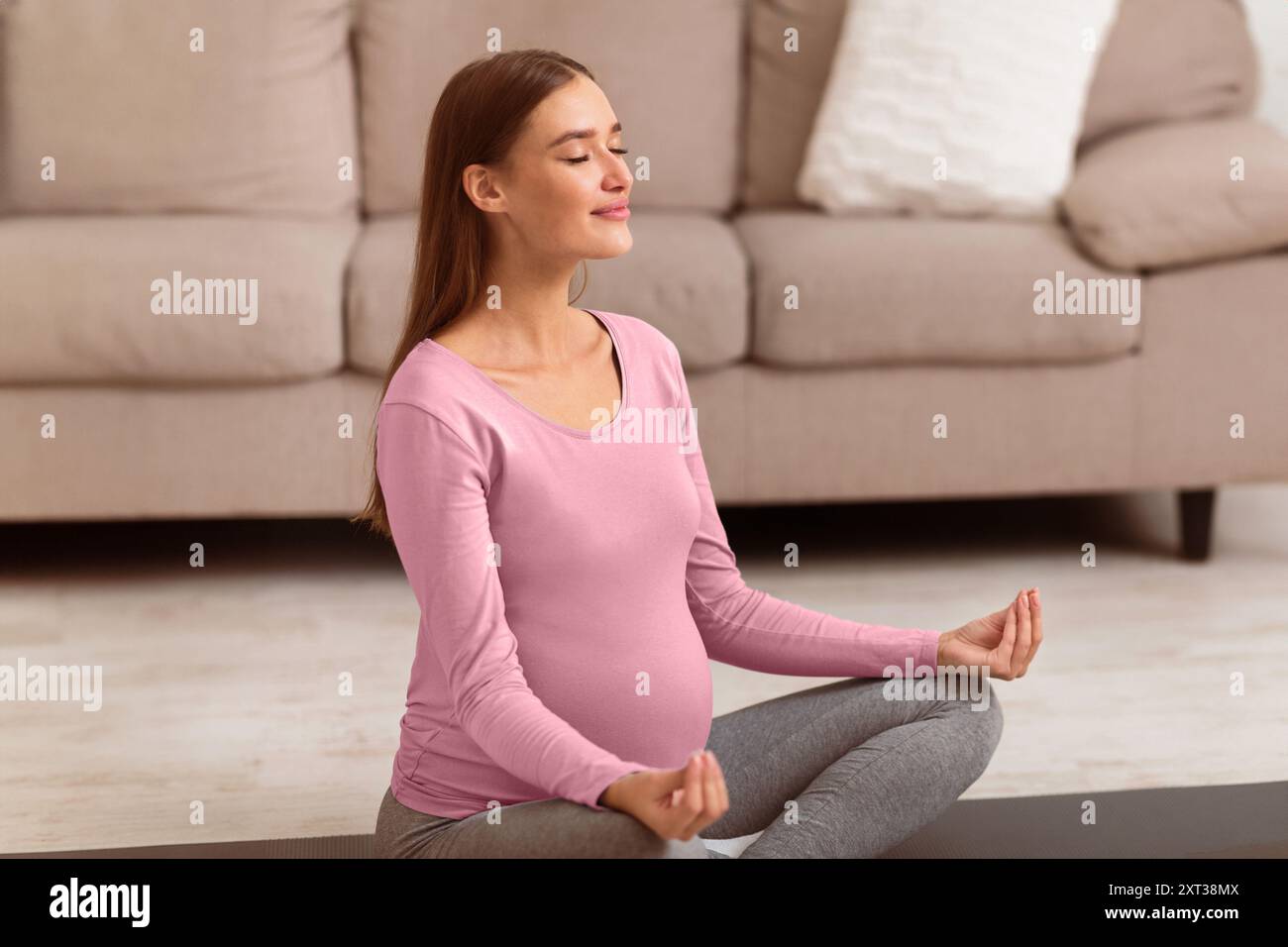 Relaxed girl meditating sitting on the floor at home Stock Photo - Alamy