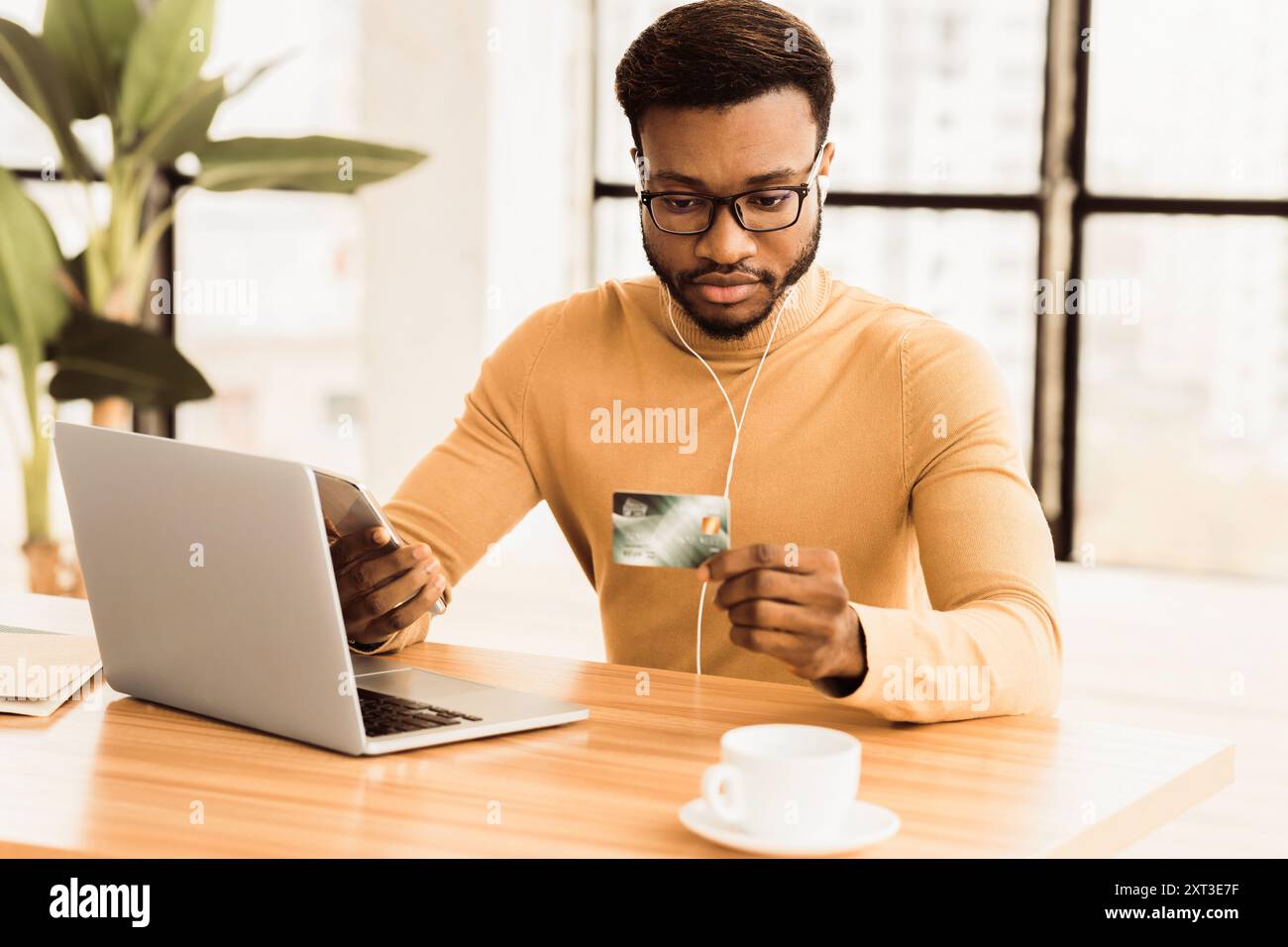 Black business man making purchases using phone Stock Photo
