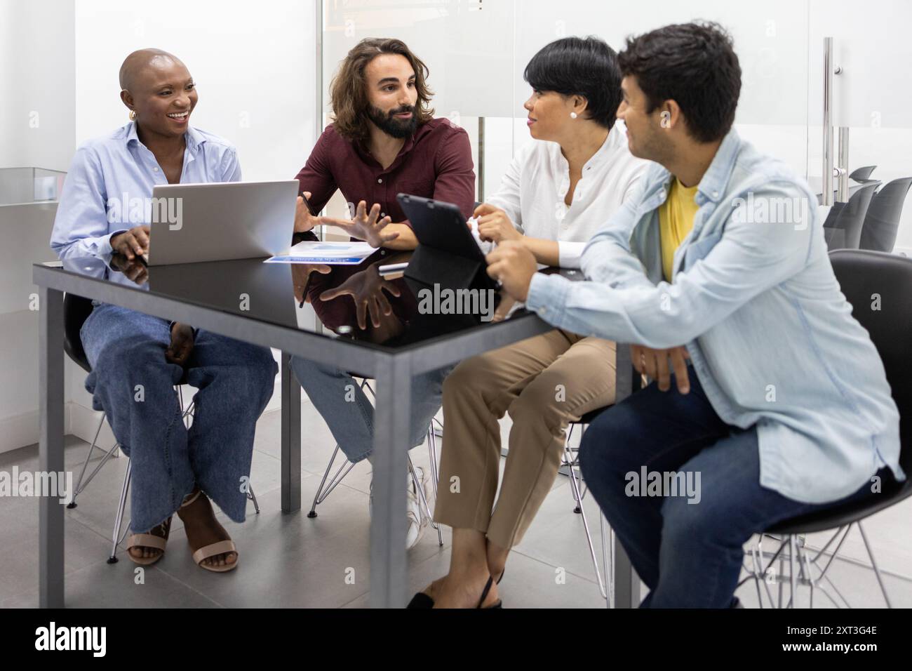 A diverse group of professionals participate in a lively discussion at an English academy, demonstrating effective communication and teamwork This ima Stock Photo