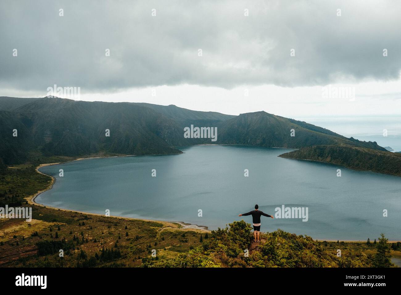 Solitary figure stands arms hi-res stock photography and images - Alamy