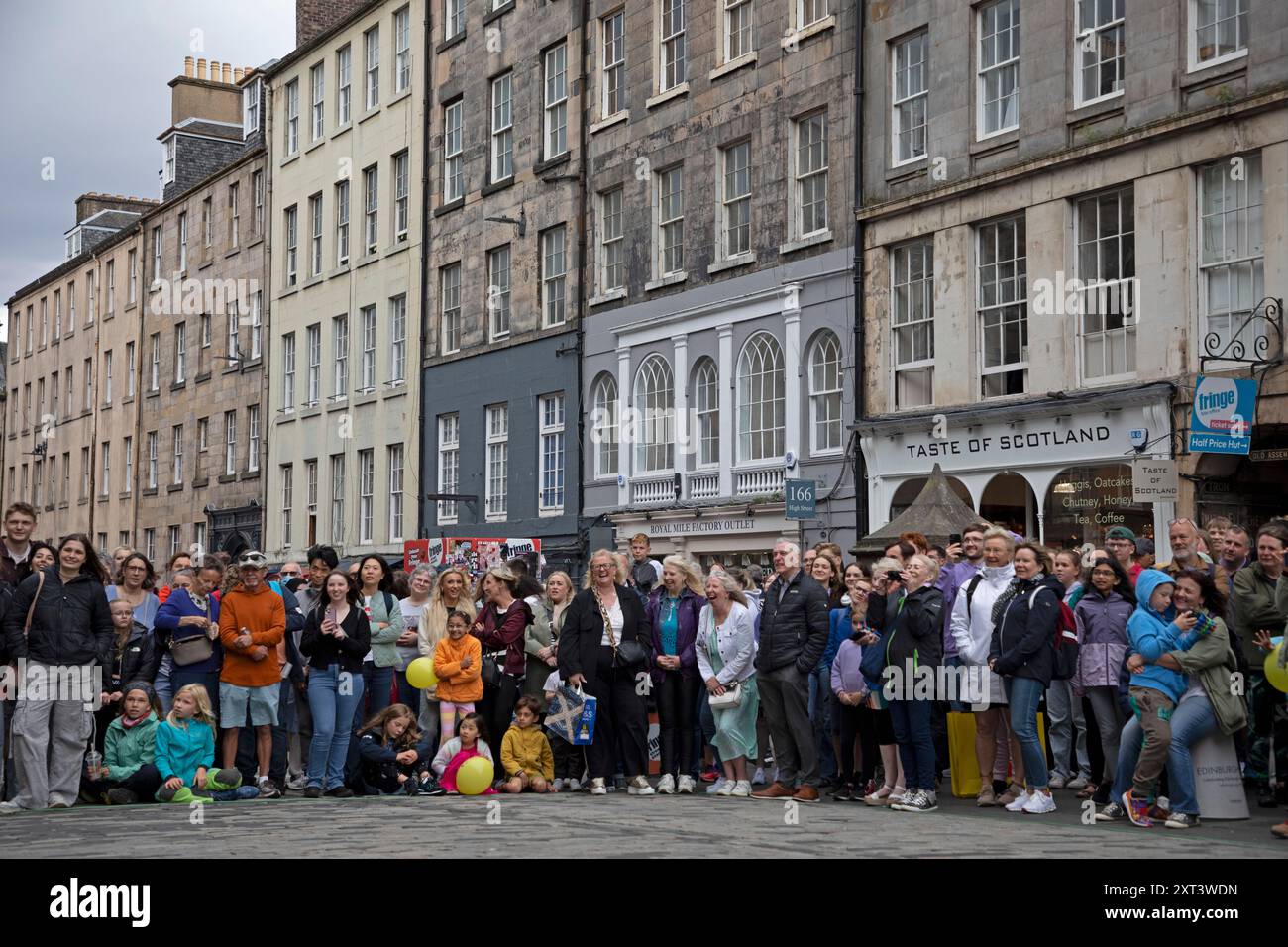 Edinburgh Festival Fringe,  Royal Mile Edinburgh, Scotland, UK, 13 August 2024. Drizzly and gusty winds for the second Tuesday on the High Street, once again weather causing street performers to vary and alter their normal routines to allow them to carry on with their shows. Credit: Arch White/alamy live news. Stock Photo