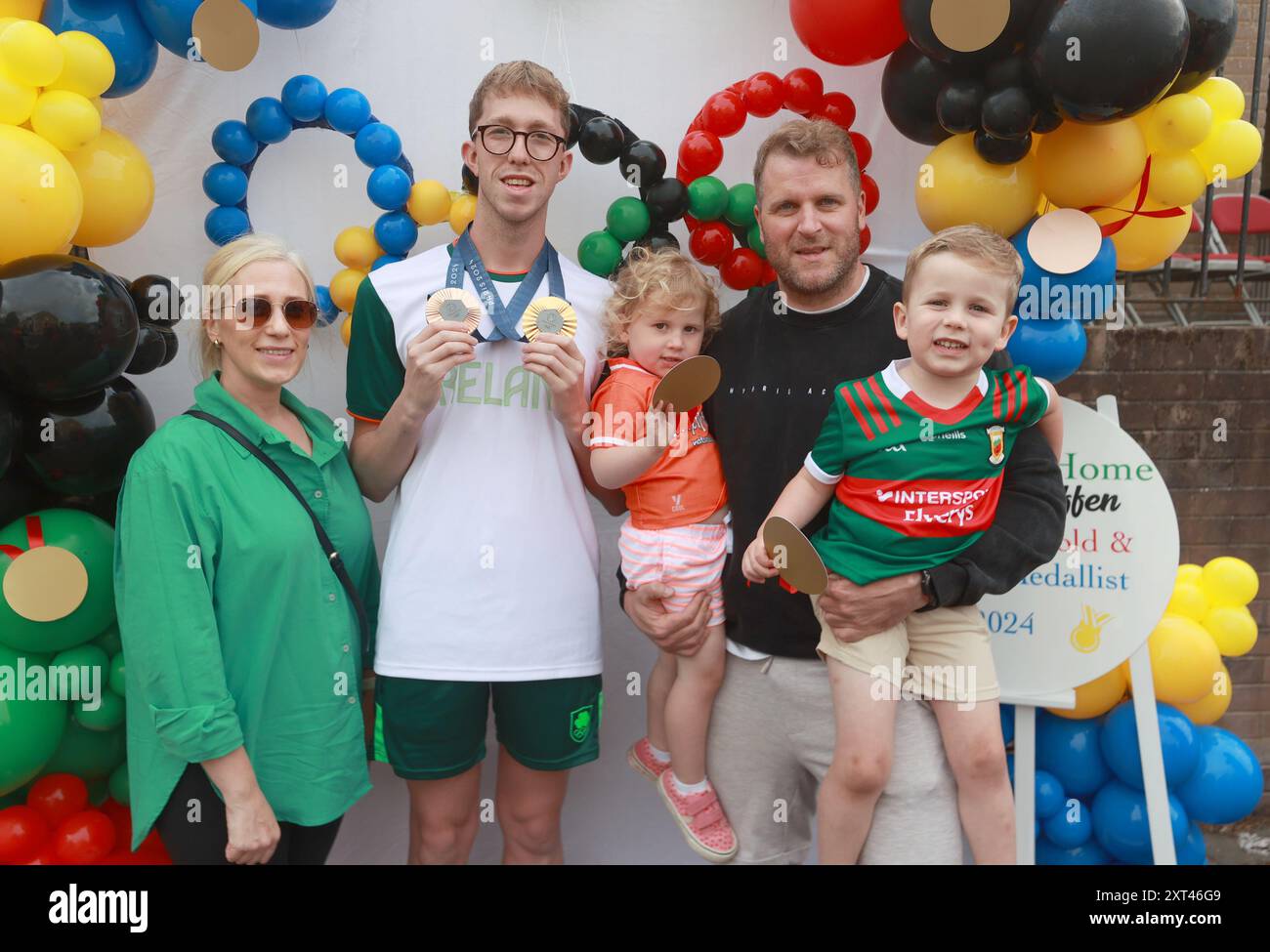 Gold and bronze medal winning swimmer Daniel Wiffen meets Michelle O'Malley, her husband Dessie and their two children Nellie, 3, and Theodore, 4, from Lurgan, during his homecoming event in Magheralin in County Down, after returning from the Paris 2024 Olympic Games. Picture date: Tuesday August 13, 2024. Stock Photo