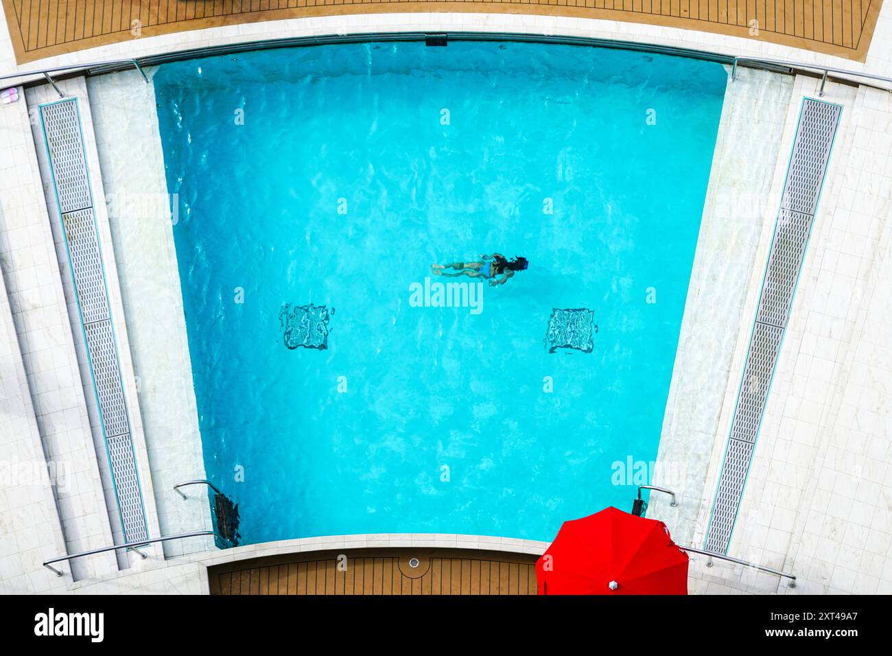 Huamn Pool Cruise liner rear relaxation zone water pool with blue water, top view ...