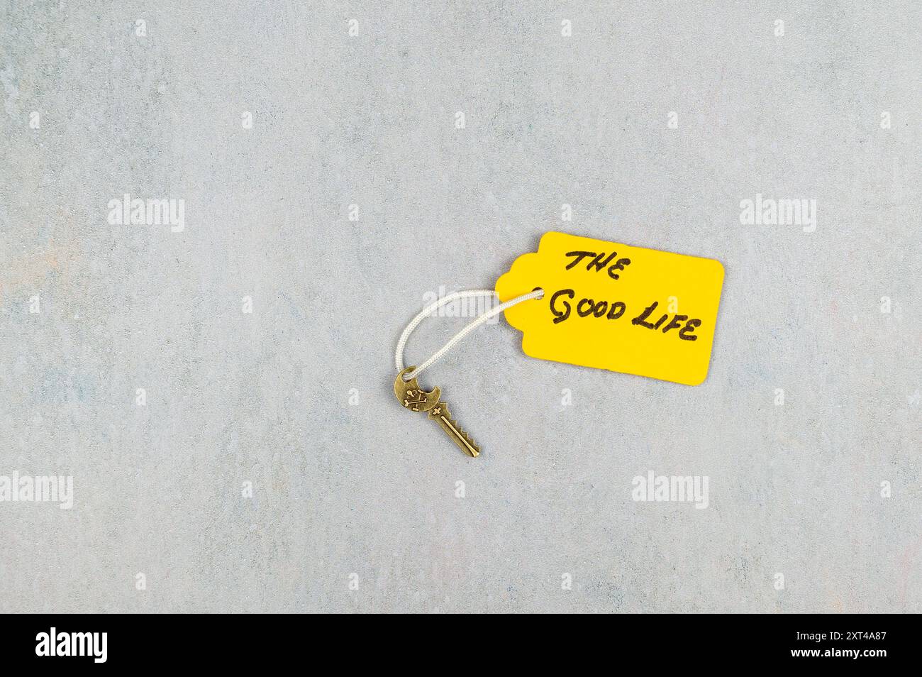 Small key with tag - concept: Key to a good life Stock Photo - Alamy