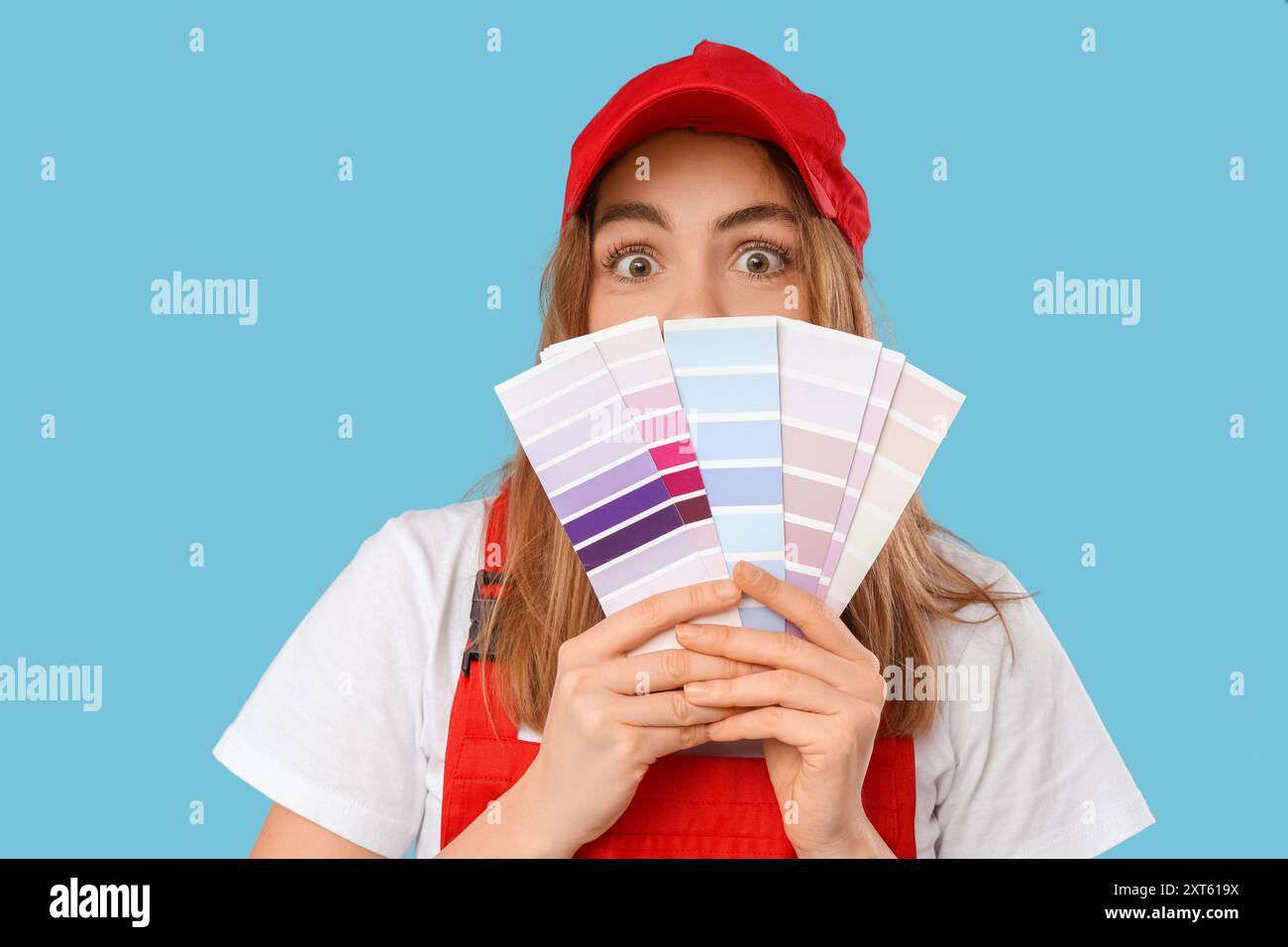 Female painter with color palettes on blue background Stock Photo - Alamy