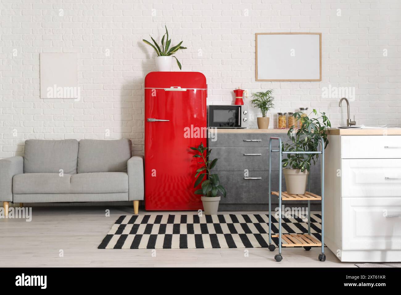 Interior of modern kitchen with red fridge and counter Stock Photo - Alamy