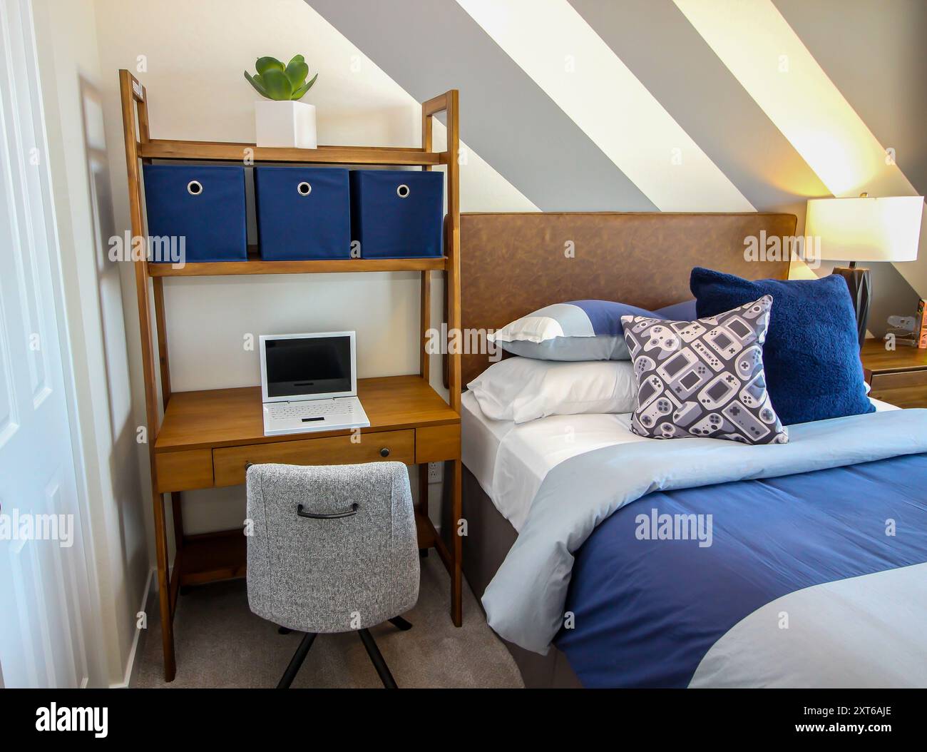 Small Wooden Desk In Guest Bedroom With Decorator Pillows Stock Photo