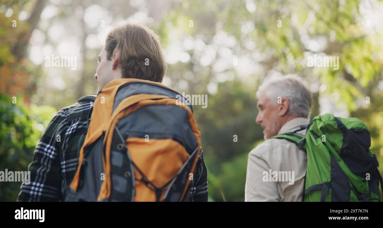 Father, son and fitness for hiking outdoor with backpacking support ...