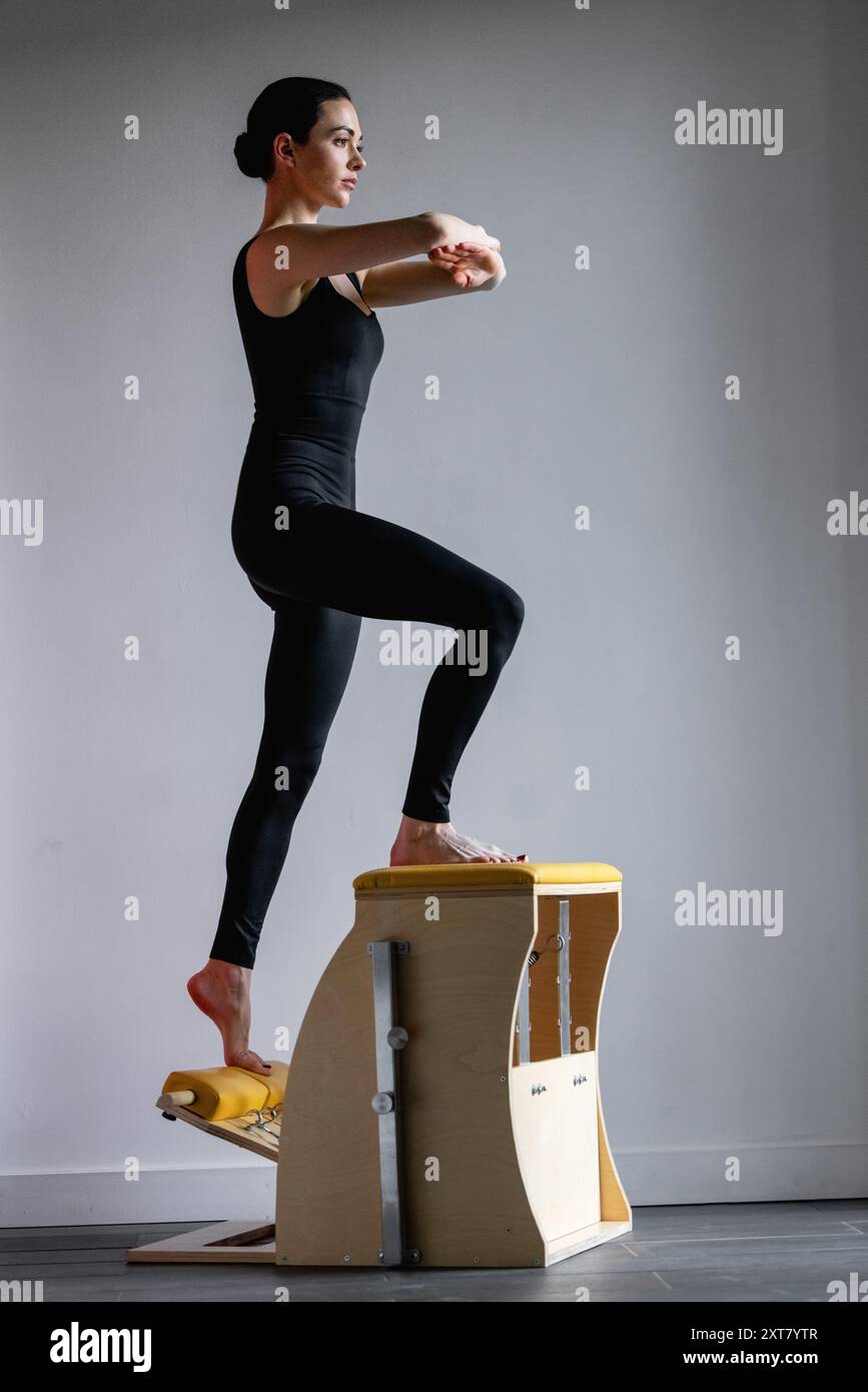 Pilates reformer chair woman fitness yoga gym exercise. Correction of ...