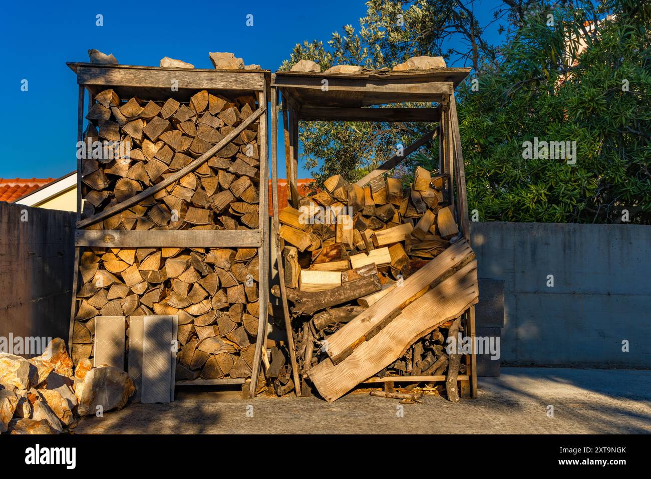 Wooden and board branches cut and stacked for the winter as fuel for the stove Stock Photo