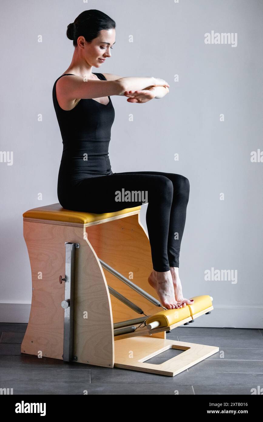 Pilates reformer chair woman fitness yoga gym exercise. Correction of ...