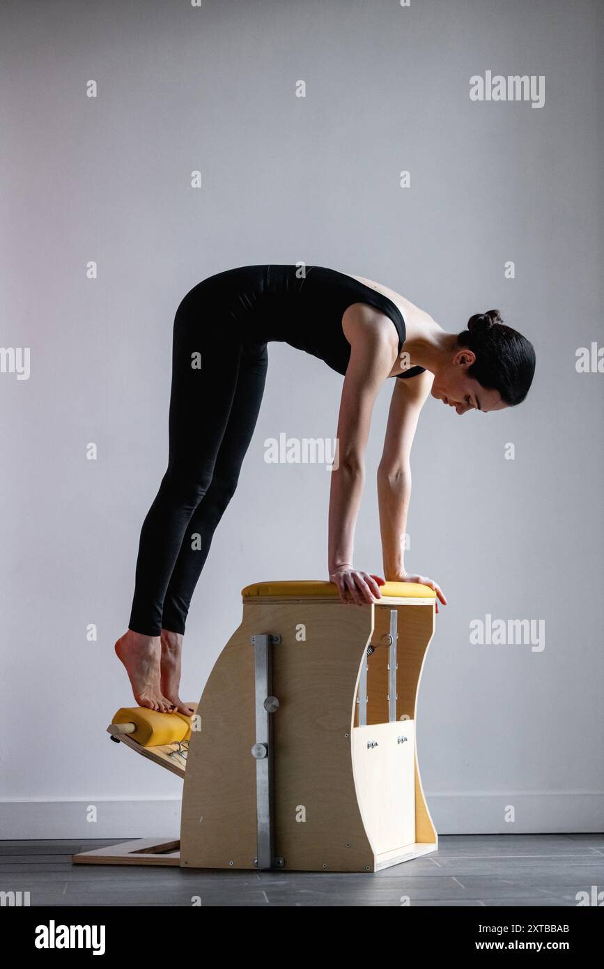 Pilates reformer chair woman fitness yoga gym exercise. Correction of ...