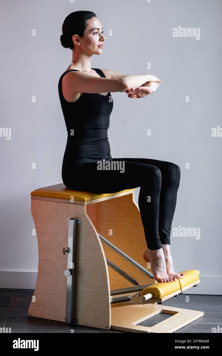 Pilates reformer chair woman fitness yoga gym exercise. Correction of ...