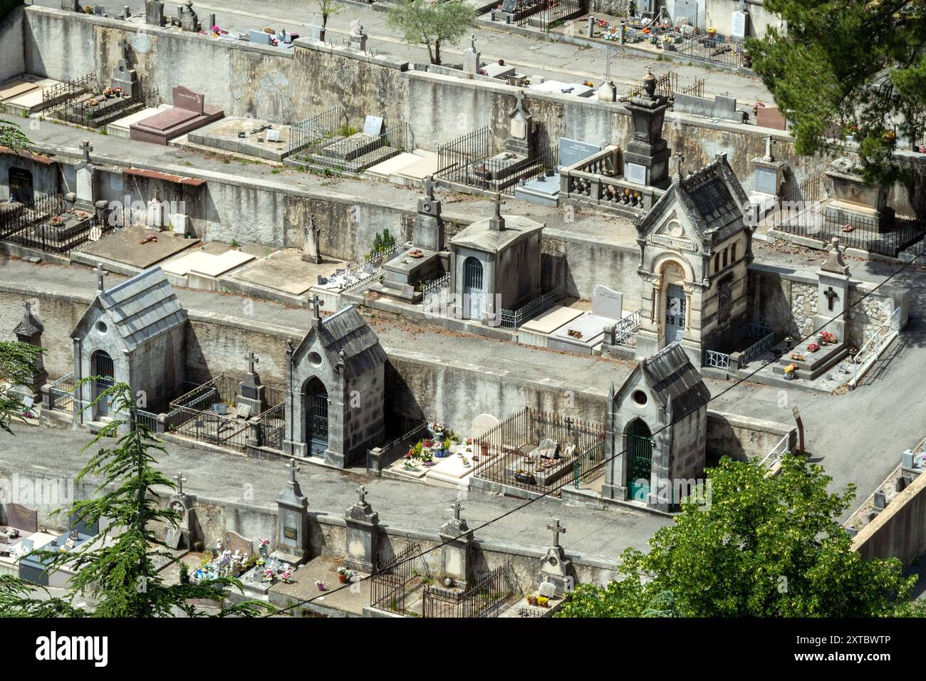 Aerial view of a cemetery with neatly arranged graves and flower decorations . France Stock Photo