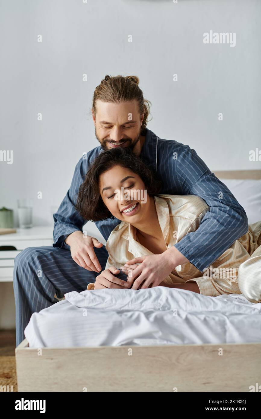 A loving couple enjoys a moment of intimacy on a bed at home Stock ...