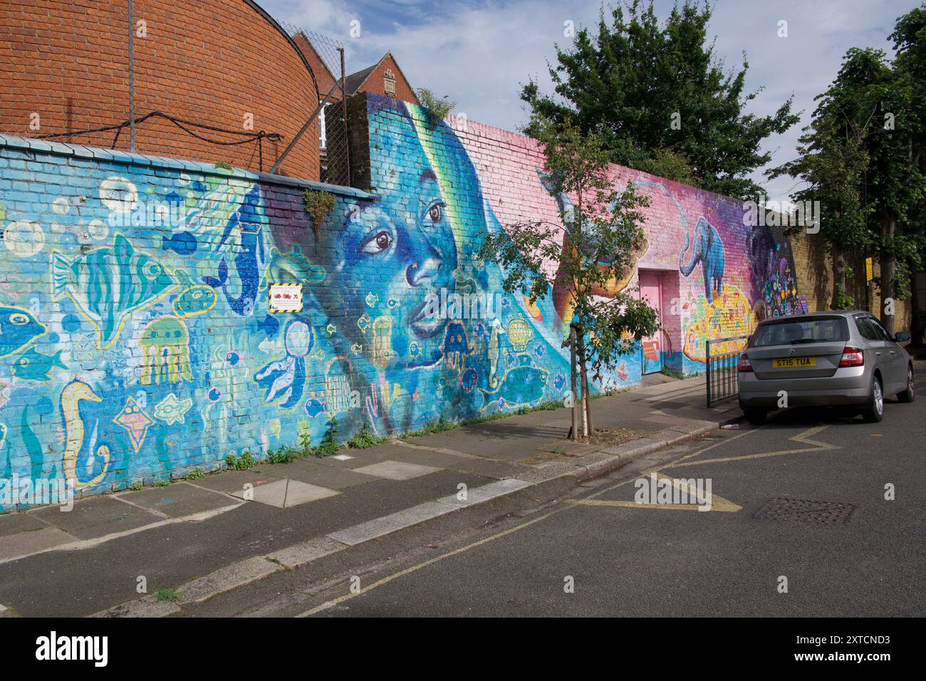 Dreaming of Unity by Joel Artista on the perimeter wall of Derwentwater Primary School Newburgh Road, London, W3 Stock Photo